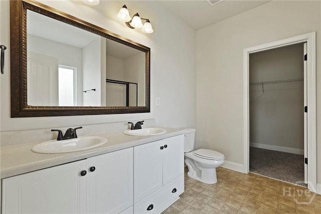 153 Whirlwind Way, Guyton, GA 31312 - bathroom with double vanity, a walk in closet, and an enclosed shower