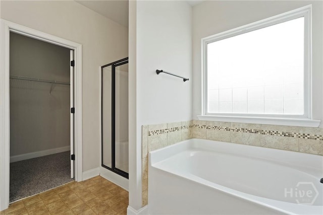 153 Whirlwind Way, Guyton, GA 31312 - bathroom featuring a shower stall, a garden tub, and a walk in closet