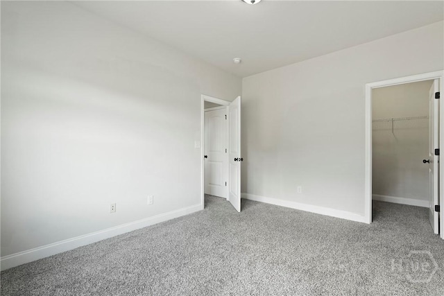 153 Whirlwind Way, Guyton, GA 31312 - unfurnished bedroom with carpet, a walk in closet, and a closet