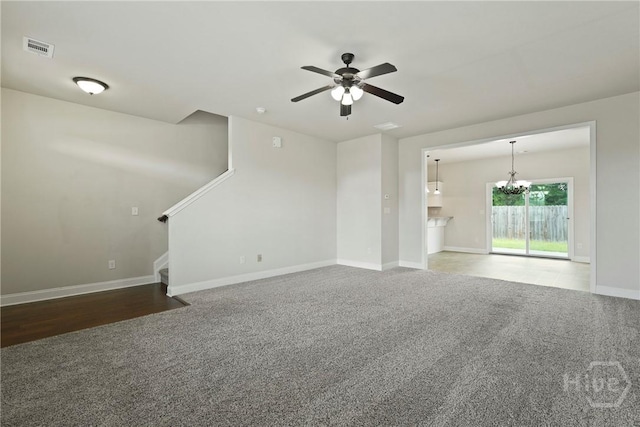153 Whirlwind Way, Guyton, GA 31312 - unfurnished living room featuring carpet floors, stairs, a ceiling fan, and a chandelier