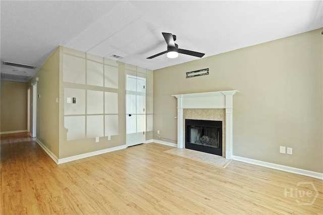 7305 Leghorn St, Savannah, GA 31406 - unfurnished living room featuring a ceiling fan, wood finished floors, and a tiled fireplace