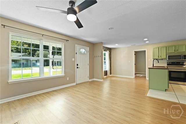 7305 Leghorn St, Savannah, GA 31406 - unfurnished living room featuring light wood finished floors, ceiling fan, recessed lighting, and a textured ceiling