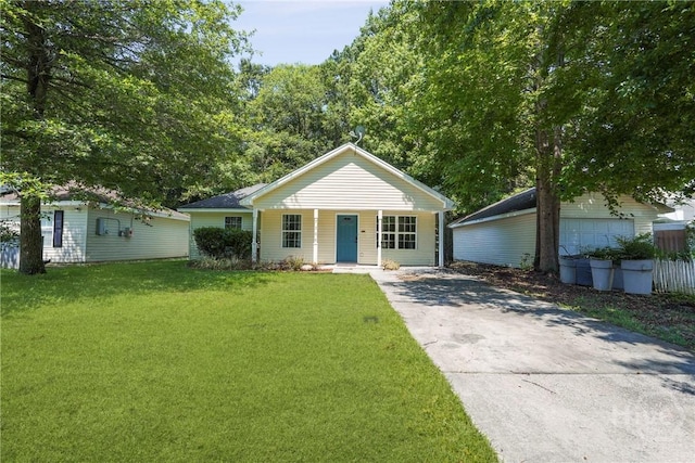 7305 Leghorn St, Savannah, GA 31406 - ranch-style house featuring a porch, a front yard, concrete driveway, and an outbuilding
