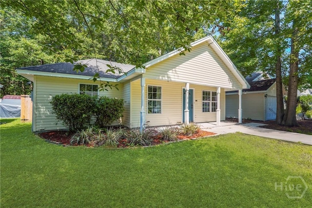 7305 Leghorn St, Savannah, GA 31406 - view of front of property with a front yard, covered porch, a shingled roof, and an outbuilding
