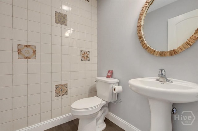 243 Forest St NE, Ludowici, GA 31316 - half bathroom featuring toilet and wood finished floors