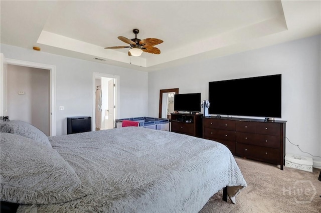 243 Forest St NE, Ludowici, GA 31316 - bedroom featuring a tray ceiling, light carpet, and ceiling fan