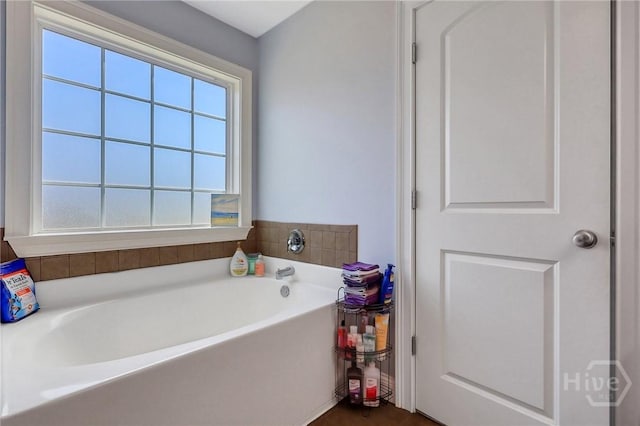 243 Forest St NE, Ludowici, GA 31316 - bathroom featuring plenty of natural light and a garden tub