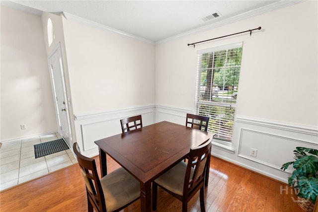 178 Junco Way, Savannah, GA 31419 - dining space featuring ornamental molding, a wainscoted wall, and light wood-type flooring