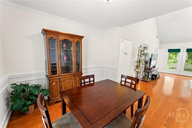 178 Junco Way, Savannah, GA 31419 - dining room featuring light wood-style floors, a wainscoted wall, ornamental molding, a decorative wall, and french doors