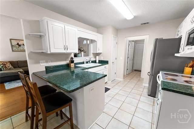 178 Junco Way, Savannah, GA 31419 - kitchen featuring white cabinets, light tile patterned floors, a peninsula, open shelves, and dark countertops