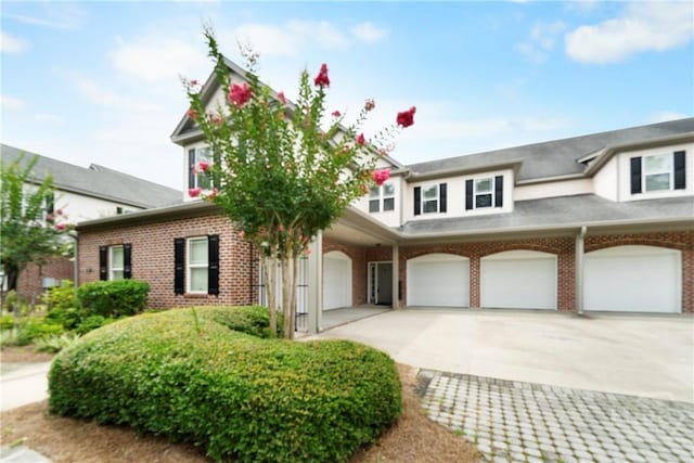 903 River Oaks Dr Unit 903, Richmond Hill, GA 31324 - view of front facade featuring a garage, brick siding, and concrete driveway