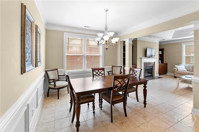 903 River Oaks Dr Unit 903, Richmond Hill, GA 31324 - dining space with ornamental molding, healthy amount of natural light, a chandelier, a high end fireplace, and a decorative wall