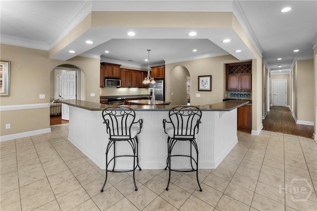 903 River Oaks Dr Unit 903, Richmond Hill, GA 31324 - kitchen featuring stainless steel appliances, arched walkways, light tile patterned floors, recessed lighting, and crown molding