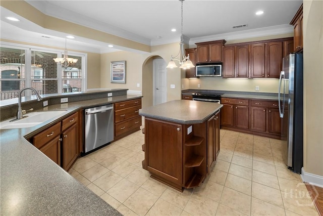 903 River Oaks Dr Unit 903, Richmond Hill, GA 31324 - kitchen with stainless steel appliances, dark countertops, a chandelier, crown molding, and arched walkways