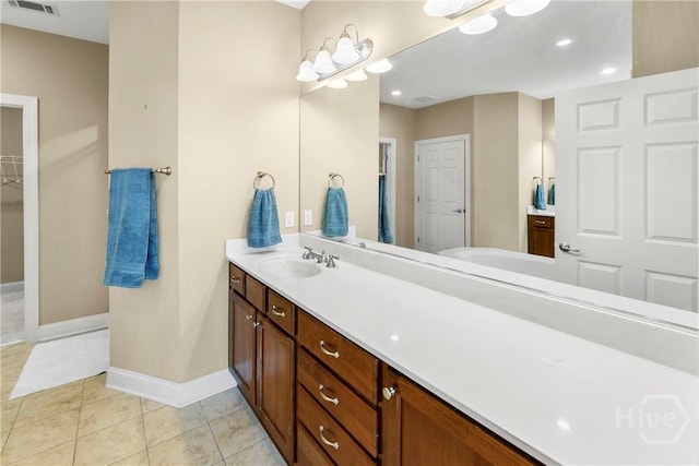 903 River Oaks Dr Unit 903, Richmond Hill, GA 31324 - bathroom with vanity, tile patterned floors, and a walk in closet