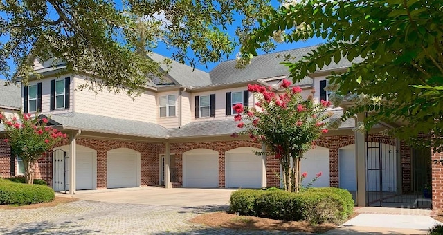 903 River Oaks Dr Unit 903, Richmond Hill, GA 31324 - multi unit property with an attached garage, driveway, brick siding, and a shingled roof