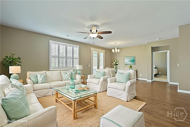 7 Saddle St N, Savannah, GA 31407 - living room featuring ceiling fan, wood finished floors, and a chandelier