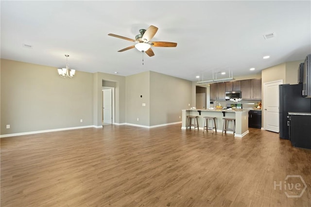 7 Saddle St N, Savannah, GA 31407 - unfurnished living room with a ceiling fan, a chandelier, wood finished floors, and recessed lighting
