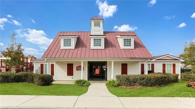 7 Saddle St N, Savannah, GA 31407 - cape cod-style house featuring a standing seam roof, a front yard, a porch, and a metal roof