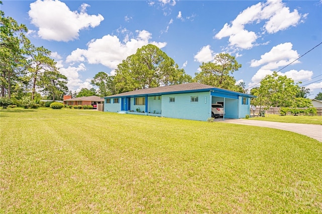 124 Drennon Dr, Jesup, GA 31545 - rear view of house with concrete driveway, a yard, and a carport