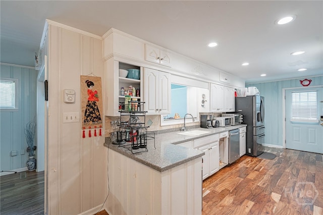124 Drennon Dr, Jesup, GA 31545 - kitchen with appliances with stainless steel finishes, light wood-type flooring, white cabinets, light stone countertops, and ornamental molding