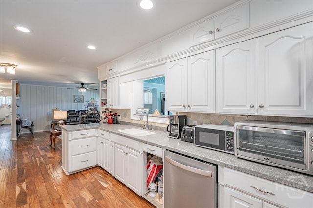 124 Drennon Dr, Jesup, GA 31545 - kitchen with stainless steel dishwasher, white cabinets, light wood-style floors, and recessed lighting
