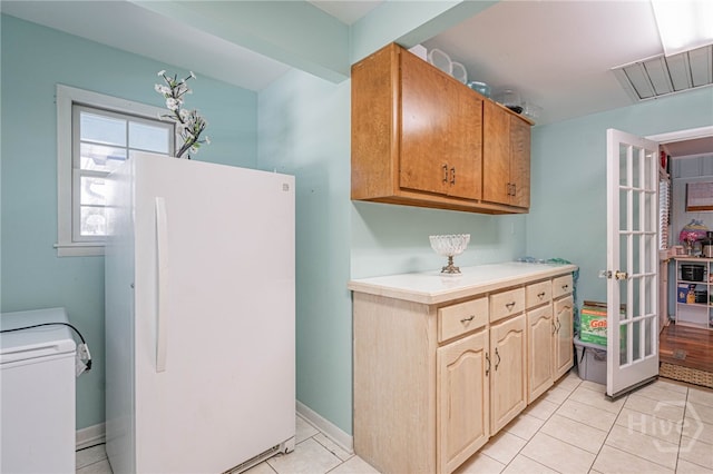 124 Drennon Dr, Jesup, GA 31545 - kitchen featuring freestanding refrigerator, washer / dryer, light countertops, and light tile patterned flooring