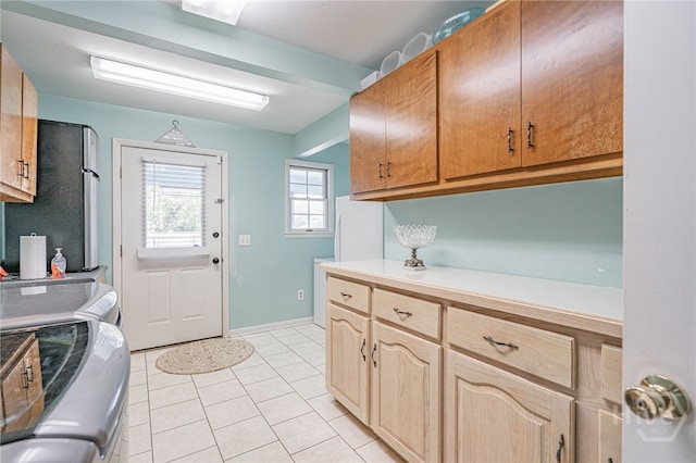 124 Drennon Dr, Jesup, GA 31545 - washroom featuring washing machine and dryer, cabinet space, and light tile patterned flooring