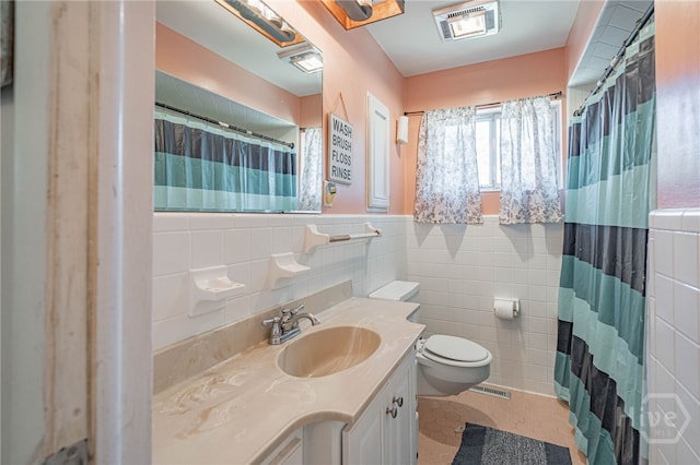 124 Drennon Dr, Jesup, GA 31545 - full bathroom featuring tile walls, vanity, curtained shower, a wainscoted wall, and tile patterned flooring