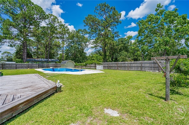 124 Drennon Dr, Jesup, GA 31545 - fenced backyard featuring a storage unit and a deck
