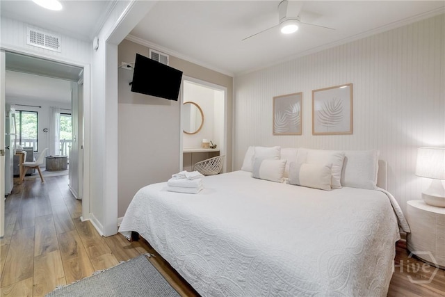 1217 Bay St Unit 109B, Tybee Island, GA 31328 - bedroom with ornamental molding, light wood-type flooring, and a ceiling fan