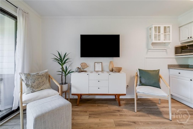 1217 Bay St Unit 109B, Tybee Island, GA 31328 - sitting room featuring ornamental molding and light wood-style flooring