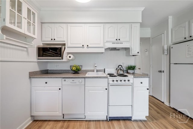 1217 Bay St Unit 109B, Tybee Island, GA 31328 - kitchen featuring white appliances, under cabinet range hood, light wood-style floors, white cabinets, and ornamental molding