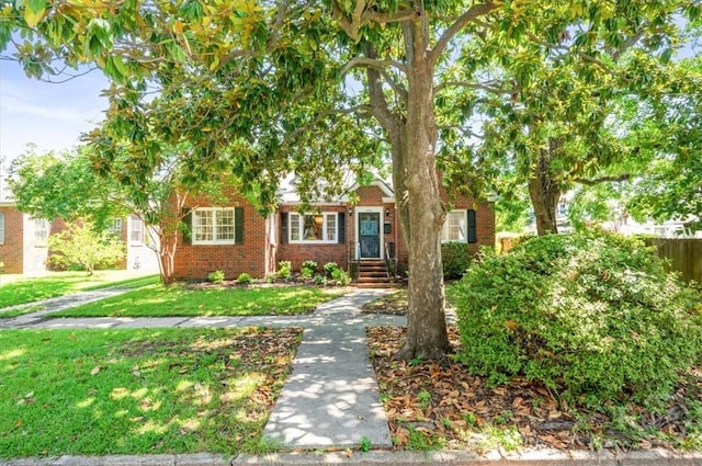 308 E 55th St, Savannah, GA 31405 - obstructed view of property featuring brick siding and a front yard