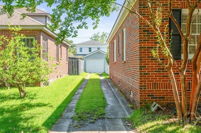 308 E 55th St, Savannah, GA 31405 - view of property exterior featuring brick siding, driveway, a lawn, a detached garage, and an outdoor structure