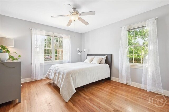 308 E 55th St, Savannah, GA 31405 - bedroom with multiple windows, light wood-style floors, and ceiling fan