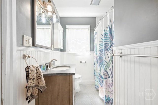 308 E 55th St, Savannah, GA 31405 - bathroom with wainscoting, vanity, and a shower with shower curtain