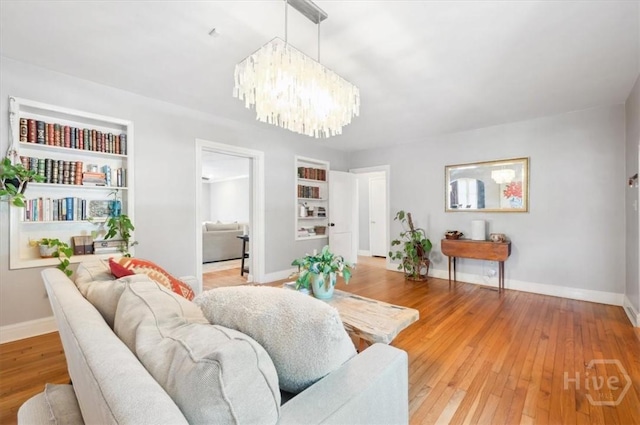 308 E 55th St, Savannah, GA 31405 - living room with a chandelier and light wood-style floors