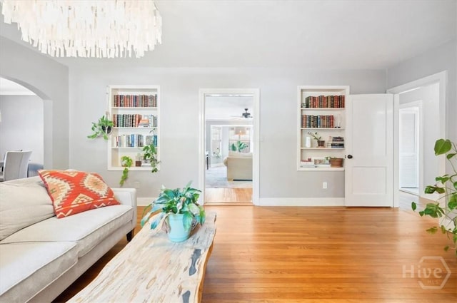 308 E 55th St, Savannah, GA 31405 - living area featuring arched walkways, light wood-style flooring, and built in shelves