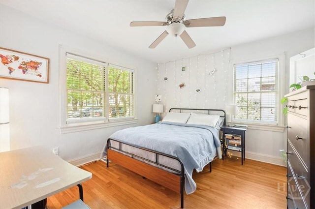 308 E 55th St, Savannah, GA 31405 - bedroom with multiple windows, wood finished floors, and a ceiling fan