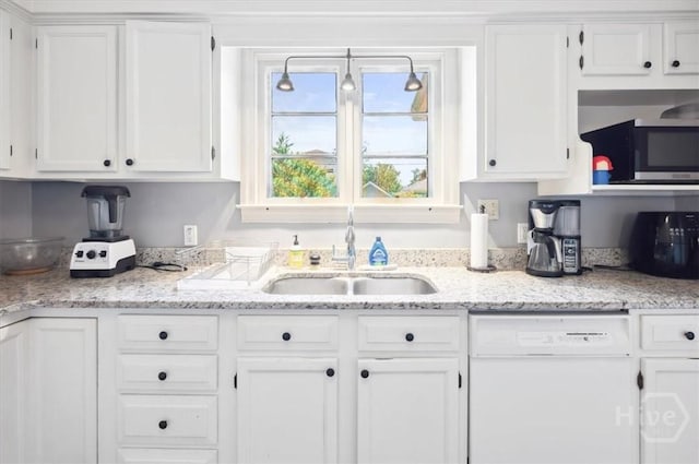 308 E 55th St, Savannah, GA 31405 - kitchen with white dishwasher, white cabinetry, and stainless steel microwave