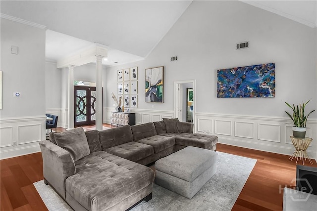 17 Hickory Grove Pt, Savannah, GA 31405 - living room featuring ornate columns, wood finished floors, crown molding, a wainscoted wall, and high vaulted ceiling