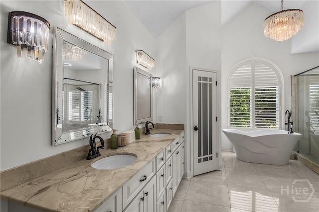 17 Hickory Grove Pt, Savannah, GA 31405 - full bathroom with double vanity, a soaking tub, a shower stall, vaulted ceiling, and a chandelier