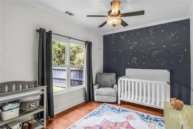 17 Hickory Grove Pt, Savannah, GA 31405 - bedroom with wood finished floors, a crib, and a ceiling fan