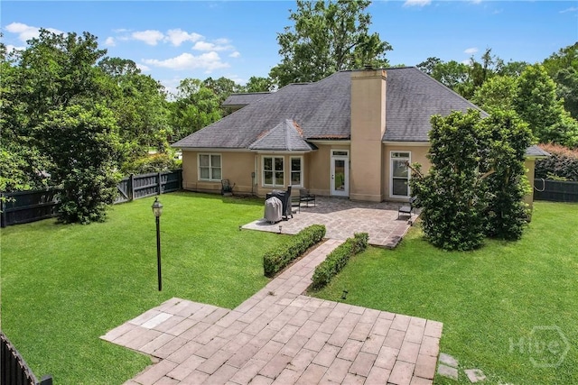 17 Hickory Grove Pt, Savannah, GA 31405 - rear view of property featuring a chimney, stucco siding, a fenced backyard, and a patio area