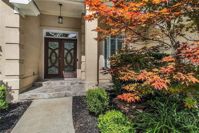 17 Hickory Grove Pt, Savannah, GA 31405 - view of exterior entry with stucco siding and french doors