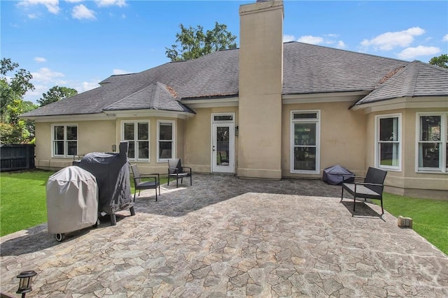 17 Hickory Grove Pt, Savannah, GA 31405 - rear view of house with stucco siding, a chimney, and a patio area