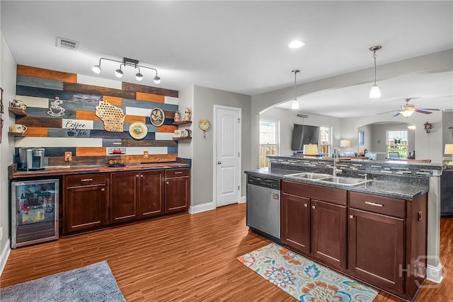 161 Laurel Ln, Guyton, GA 31312 - kitchen with wine cooler, arched walkways, stainless steel dishwasher, ceiling fan, and wood finished floors