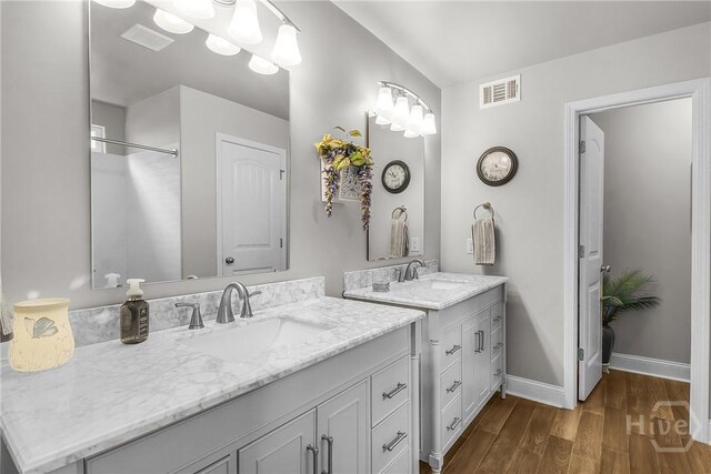 161 Laurel Ln, Guyton, GA 31312 - full bathroom featuring two vanities and wood finished floors