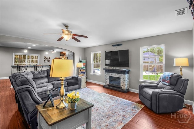 161 Laurel Ln, Guyton, GA 31312 - living area featuring healthy amount of natural light, a ceiling fan, wood finished floors, and a stone fireplace